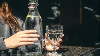 drink-water-bottle-with-glass-table-restaurant.webp