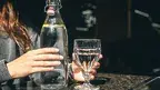 drink-water-bottle-with-glass-table-restaurant.webp